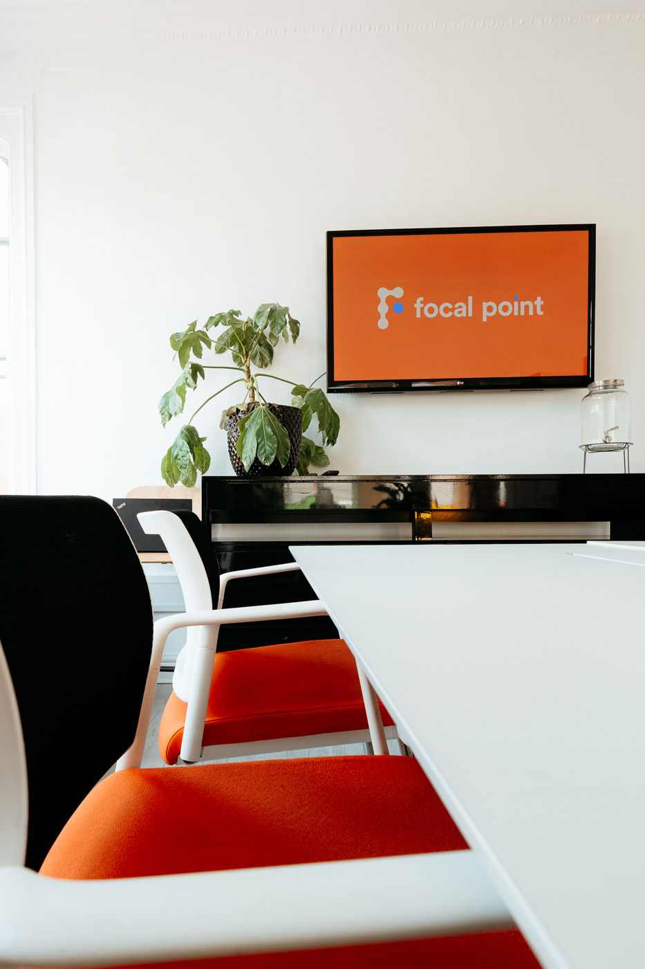 A close up of a desk and chairs at a meeting room at Focal Point